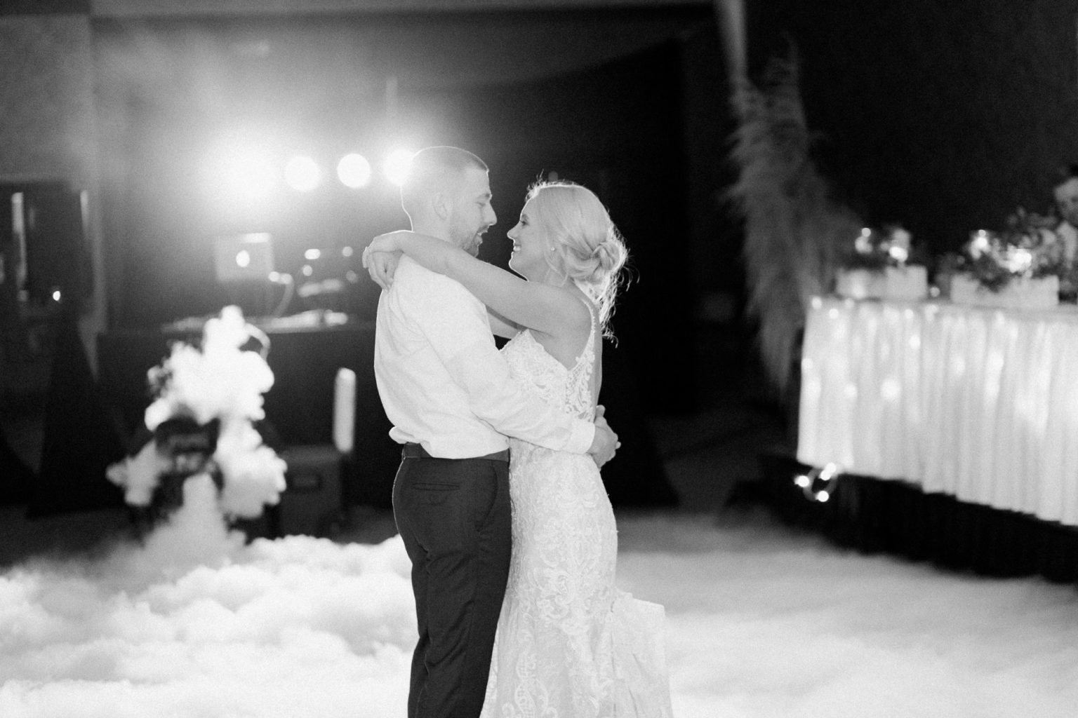 A couple sharing their first dance surrounded by low fog